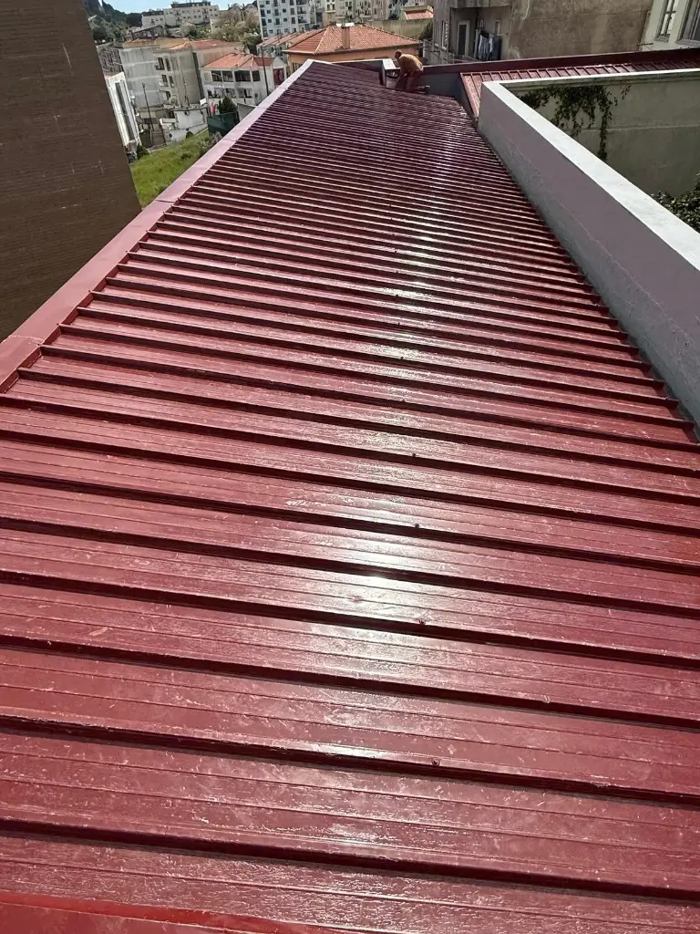 Technician finishing a sandwich-panel roof