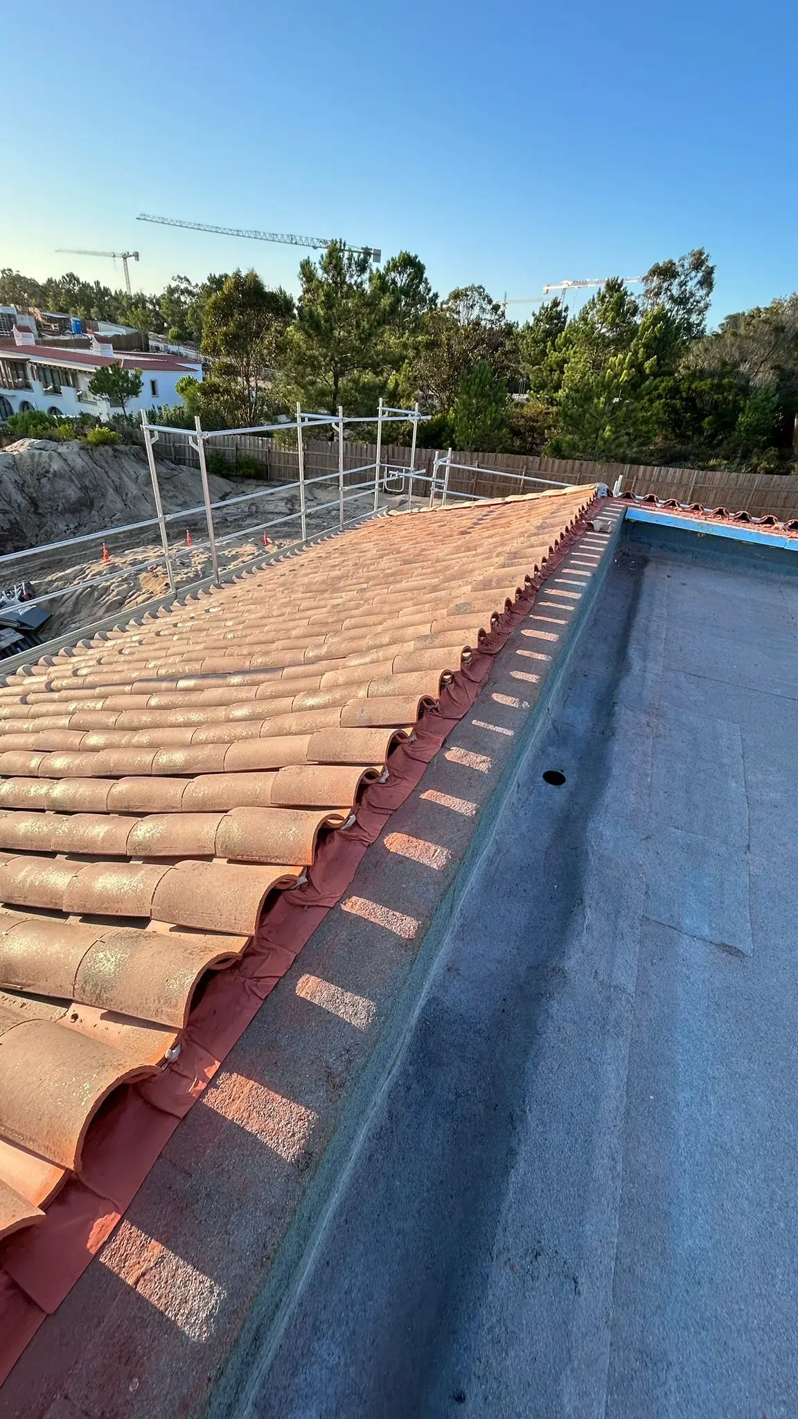 Flat terrace beside a clay-tile roof plane